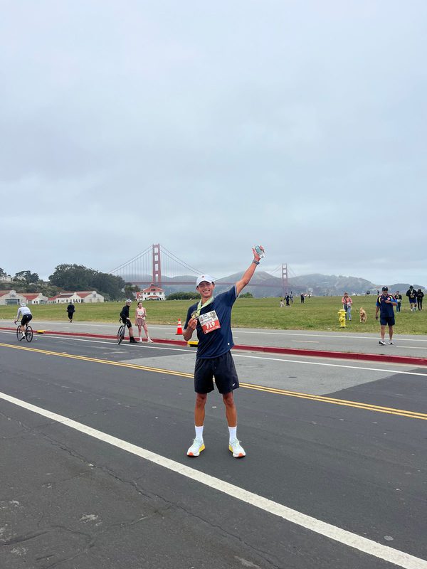 Felipe running a road race with the Golden Gate Bridge behind him